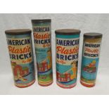 A selection of American Elgo plastic brick sets in four original cylindrical containers