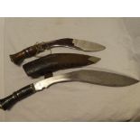 An old Gurkha service kukri with curved blade and polished wood hilt in leather sheath and one