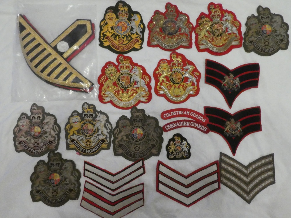 A collection of Guards badges and insignia including numerous RSM embroidered wire and cloth arm