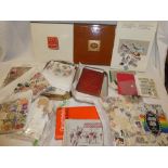 A box containing various stamp yearbooks including 1984 and 1987, stamp catalogues,