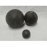 Three various iron cannon balls, 4" diameter,