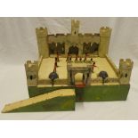 An early Triang wooden fort in cream with twin metal turret guns and metal drawbridge together with
