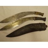 An old Gurkha kukri with 14" blade and steel hilt in leather sheath and one other kukri with brass