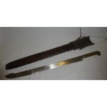 An old South American-style sword with 21" single edged blade and heavy brass hilt in tooled