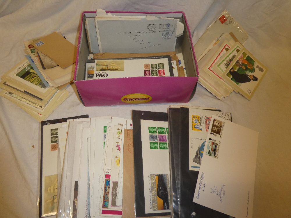 A box containing a collection of GB first day covers and various other postal covers,