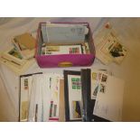 A box containing a collection of GB first day covers and various other postal covers,