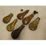 A selection of various brass and copper powder flask bodies and parts