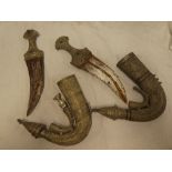 Two 20th Century Eastern Jambiya daggers in decorative sheaths
