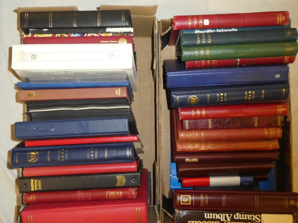 Two boxes containing a large selection of empty stock albums, stamp folder albums and others,