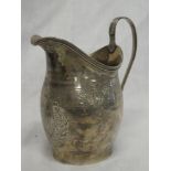 A George III silver tapered cream jug with engraved decoration and loop handle,