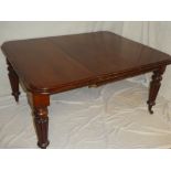 A Victorian mahogany rectangular extending dining table with one additional centre leaf on turned