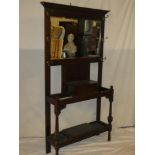 A 1920s/30s oak hall stand with bevelled rectangular mirror back and central compartment on turned