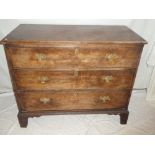 A 19th Century mahogany chest of three long drawers with brass ring handles on bracket feet