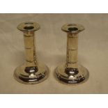 A pair of Edward VII silver squat-shaped candlesticks on circular spreading bases, 5" high,