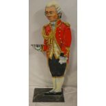 An unusual painted wood waiter figure in the form of a footman,