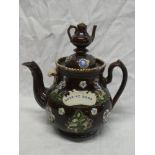 A 19th Century Bargeware circular teapot with raised bird and floral decoration "Love At Home" with