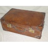 A good quality old leather rectangular suitcase with brass mounts,