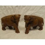 A pair of African carved wood figures of elephants,