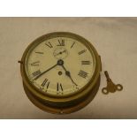 A ship's-style wall clock with painted circular dial by Newman & Field Limited Birmingham in brass