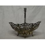 A George V silver oval sweetmeat bowl with pierced decoration and swing handle,