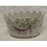 A Eastern-style oval china planter with painted bird decoration,
