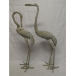 A pair of aluminium figures of storks,
