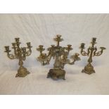 A good quality brass six-branch table candle light with raised scroll decoration together with two