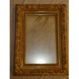 An old rectangular wall mirror in ornate gilt plaster mounted frame,