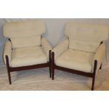 A pair of 1960s G-Plan mahogany easy chairs upholstered in white buttoned fabric