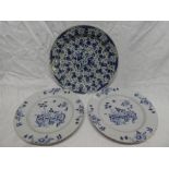 A pair of 18th Century blue and white Delft circular chargers with painted floral decoration 13"