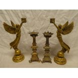 A pair of modern angel decorated candlesticks,