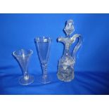 A 19th Century cut glass claret jug with faceted stopper and scroll handle,