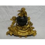 A French Empire-style mantel clock with black spherical dial in gilt spelter ornamental case