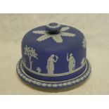 A Wedgwood-style blue jasperware circular stilton dish and cover with raised classical figure