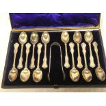 A set of twelve Victorian silver teaspoons with engraved initials together with matching sugar