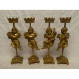 A set of four modern composition candlesticks in the form of cherub musicians,