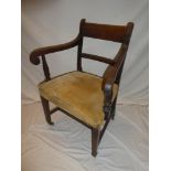 A 19th Century mahogany carver armchair with rail back and upholstered seat and square-shaped legs