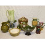 A selection of majolica and green glazed pottery including majolica cylindrical stilton dish and