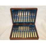 A set of six silver plated tea knives and forks with ivorine handles and a set of six matching fish