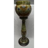 A Royal Doulton pottery circular jardiniere with raised floral decoration on green and brown ground,
