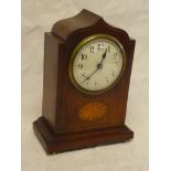 An Edwardian mantel clock with enamelled circular dial in inlaid mahogany arched case with brass