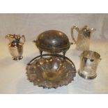 A silver plated oval food warming dish with hinged cover, tapered water pot, bottle holder,