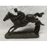 A modern bronzed resin figure of a horse and jockey