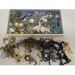 A jewellery box containing a quantity of various costume jewellery including necklaces, earrings,