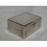 A George V silver rectangular cigarette box with engined turned hinged lid,