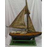 An old wooden model pond yacht with mast, sails and stand,