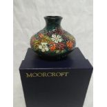 A 1998 Moorcroft pottery "Carousel" pattern squat-shaped vase, Centenary Numbered Edition No.