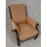 A Victorian carved mahogany easy chair upholstered in pink fabric on turned tapered legs (af)
