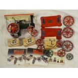 A Mamod steam tractor, various traction engine wheels, two boxed power hammers, grinding machine,