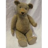 An old plush covered straw-filled teddy bear 23" long